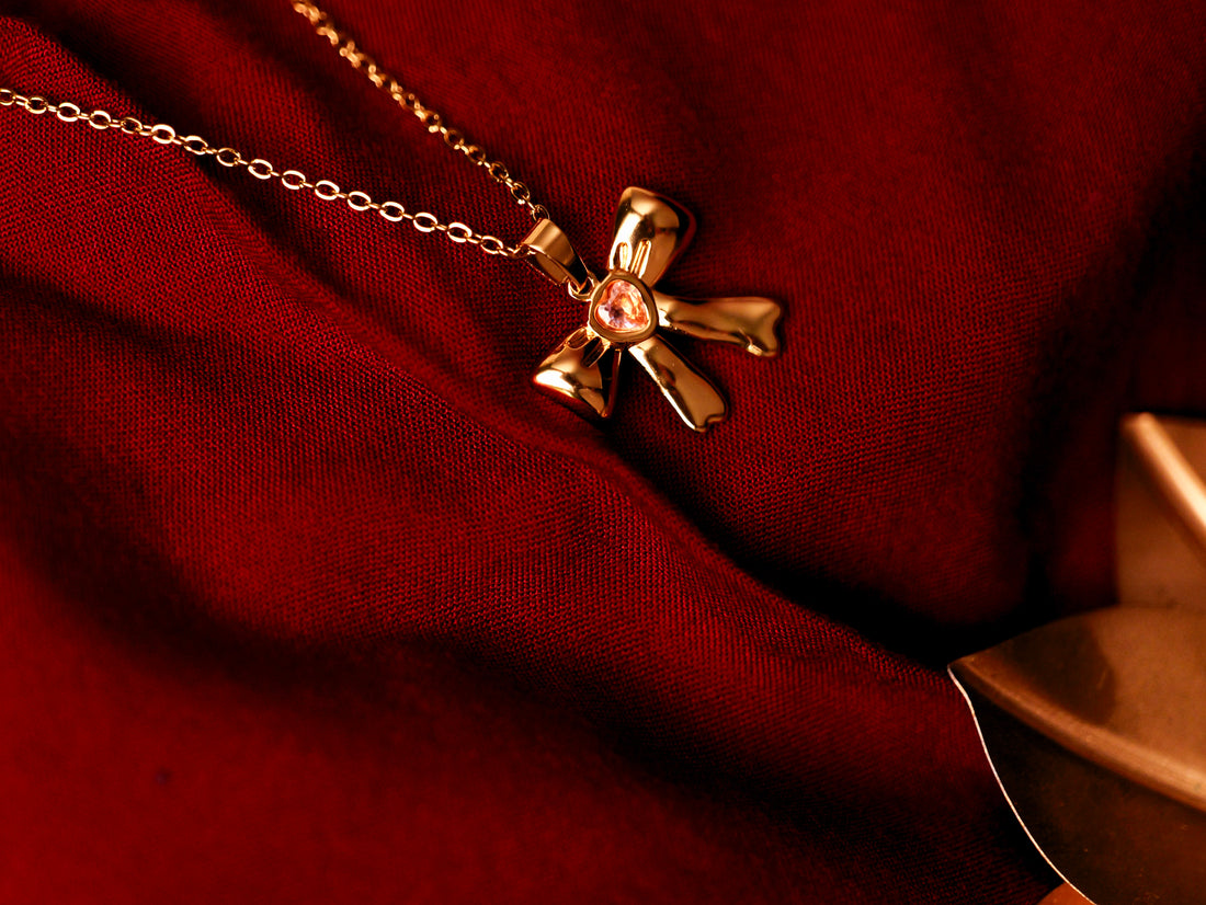 ✨ Golden Bow Pendant with Pink Stone