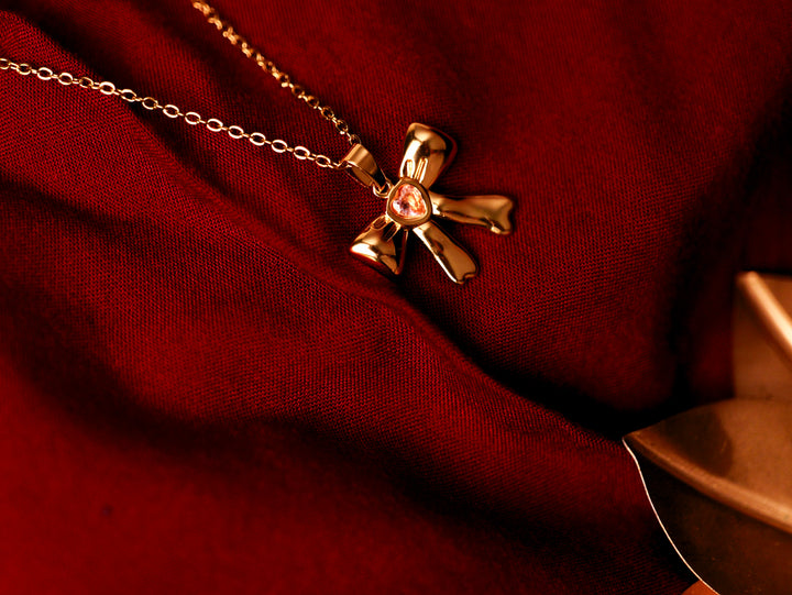 ✨ Golden Bow Pendant with Pink Stone
