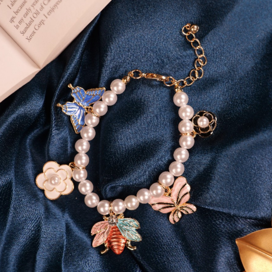Elegant Pearl Charm Bracelet with Enamel Butterfly Accents
