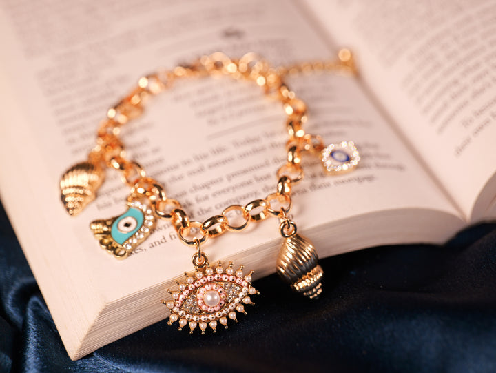 Elegant Gold-Tone Charm Bracelet with Symbolic Charms