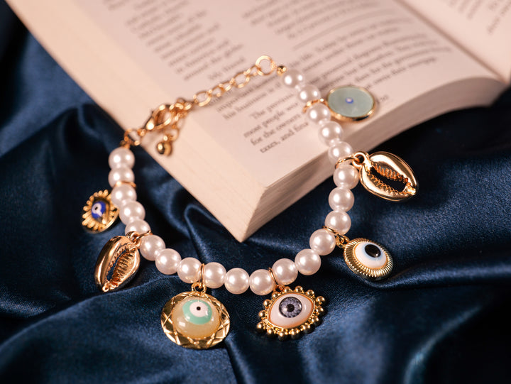 Elegant Pearl Charm Bracelet with Evil Eye & Seashell Accents